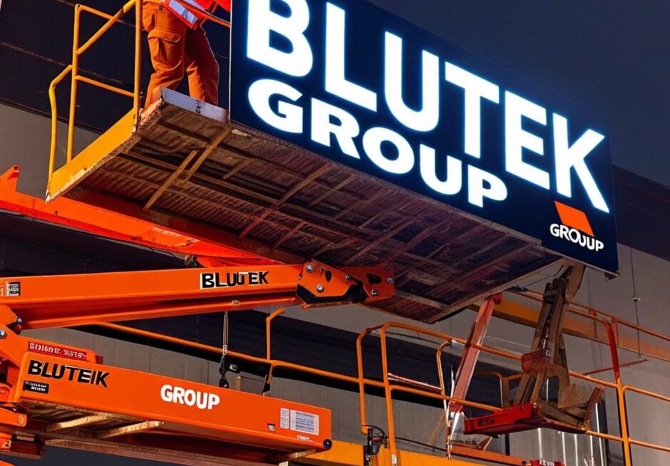 Sign,Fitters,Putting,Up,Glowing,Signs,That,Read,'blutek,Group'